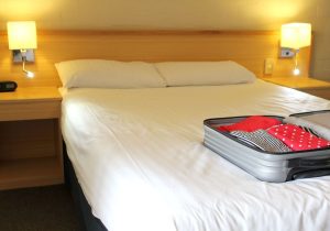 Aopen suitcase on a bed in a toursit rental
